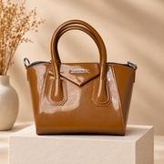 A05 caramel handbag on warm beige studio pedestal